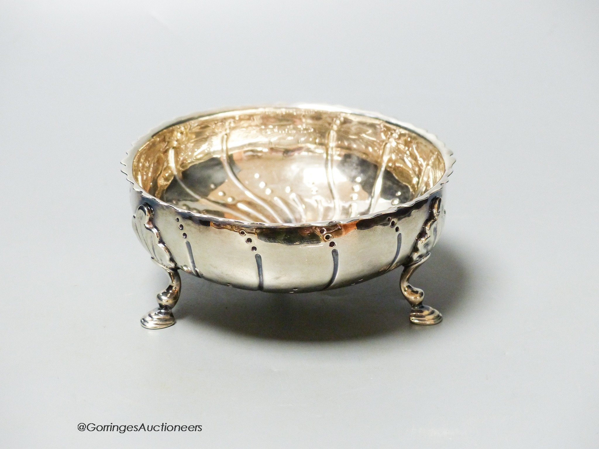 A Victorian repousse silver bowl, on three hoof feet, London, 1871, diameter 12.6cm, 6oz.